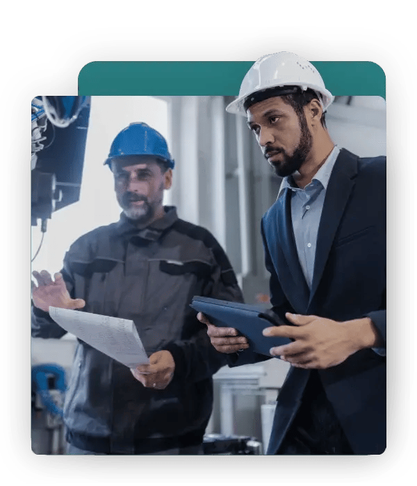 Executive reviewing production data with a plant engineer in an industrial manufacturing facility
