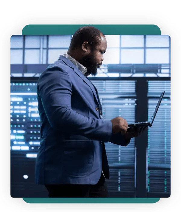 Leader with a laptop in a data center, industrial technology recruiters and professional search