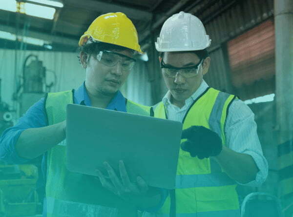 An industrial manager training a junior manager and engaging in succession planning.