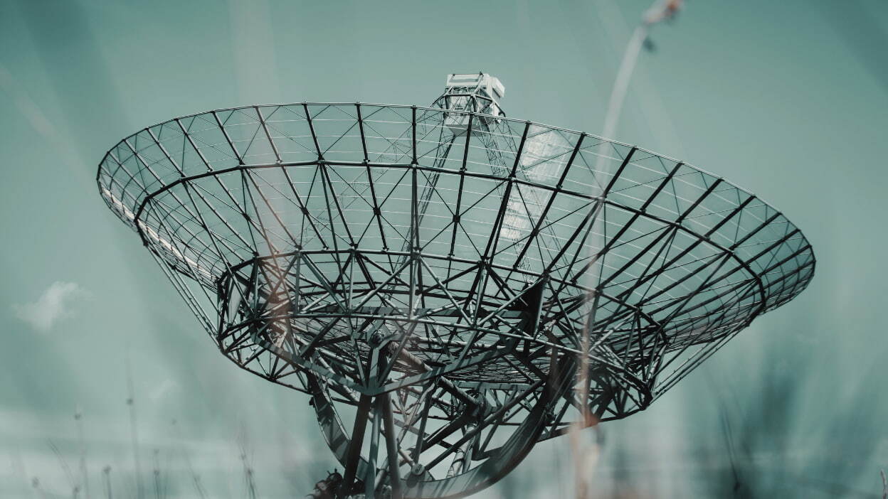 Large satellite communications antenna against the sky for telecommunications infrastructure.