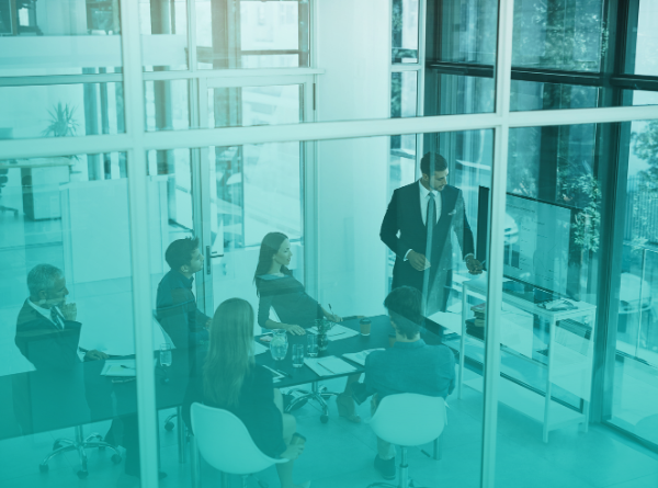 man presenting in a conference room to group of people